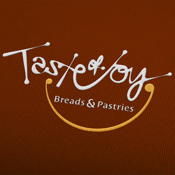Logotipo Taste of Joy bordado, criado pela Ópera Criativa para a panificadora artesanal de São Paulo